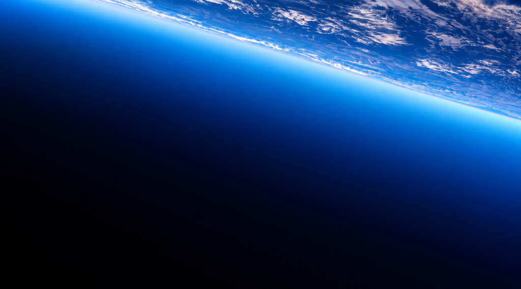 Earth curvature from space with glowing electric blue atmosphere at top right